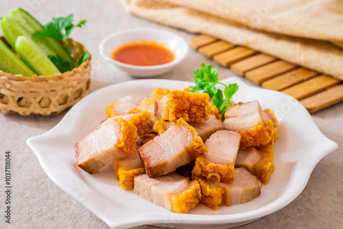 Crispy pork belly on white plate and dipping sauce