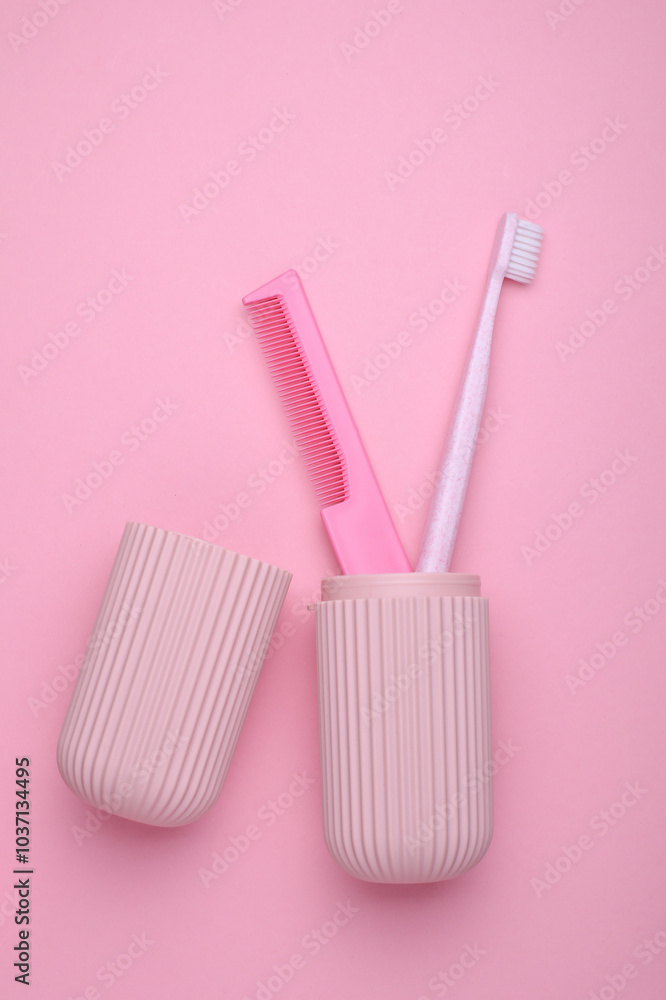 Organizer case with toothbrush and comb on pink background Organizer case with toothbrush and comb on pink background