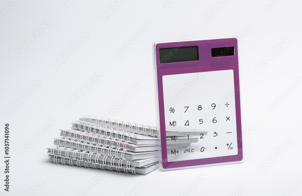 Calculator with stack of notebooks on white background Calculator with stack of notebooks on white background