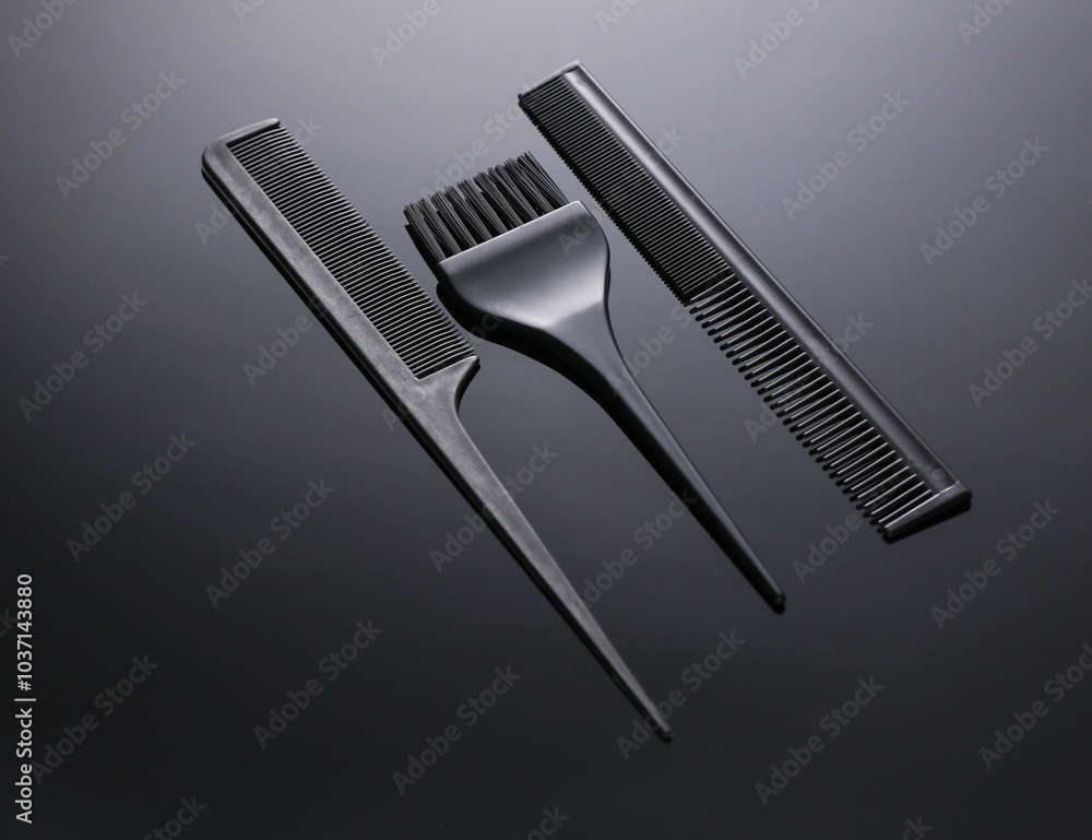 Comb and brush for hair dyeing on black background Comb and brush for hair dyeing on black background