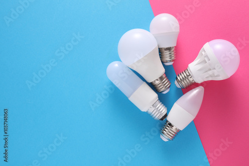 LED light bulbs of different shapes on blue pink background photo