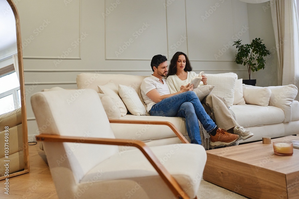 Couple enjoying quality time together in a cozy living room at home Couple enjoying quality time together in a cozy living room at home