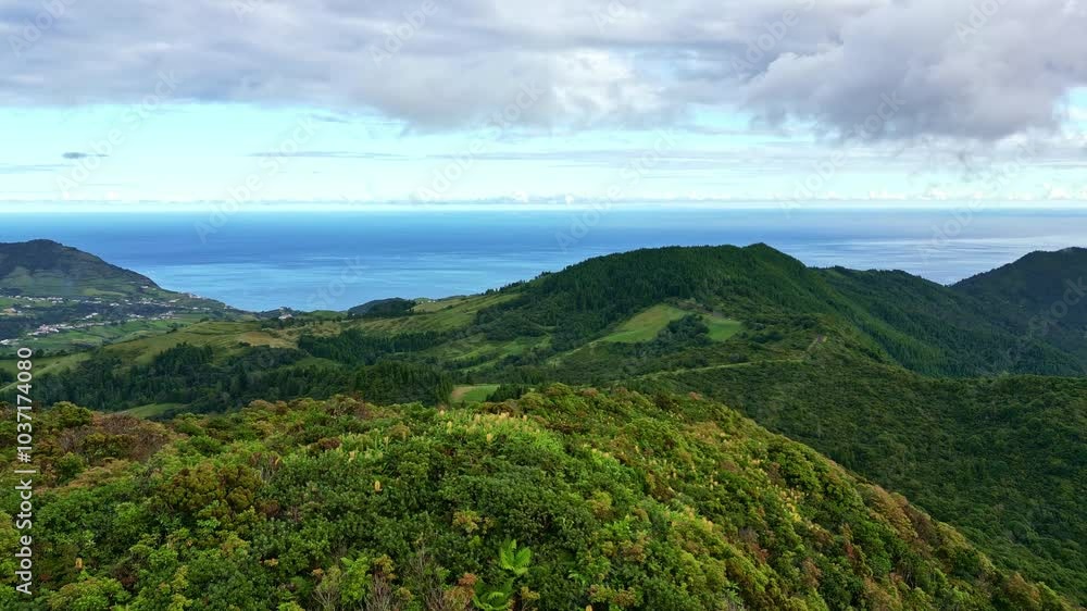 Beautiful aerial drone video of a nature mountain landscape near Salto do Cavalo viewpoint. Camera flies over the hill showing mountain road and green valley. Sao Miguel island, Azores, Portugal Beautiful aerial drone video of a nature mountain landscape near Salto do Cavalo viewpoint. Camera flies over the hill showing mountain road and green valley. Sao Miguel island, Azores, Portugal