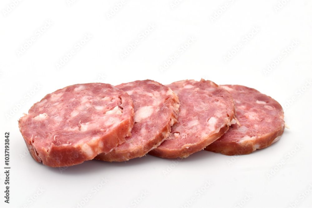 Slices of sliced salami sausage lie on a white background. Slices of sliced salami sausage lie on a white background.