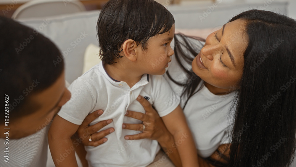 Family spending time together with a woman, a man, and a child inside a cozy living room, showing love and warmth in a home setting. Family spending time together with a woman, a man, and a child inside a cozy living room, showing love and warmth in a home setting.