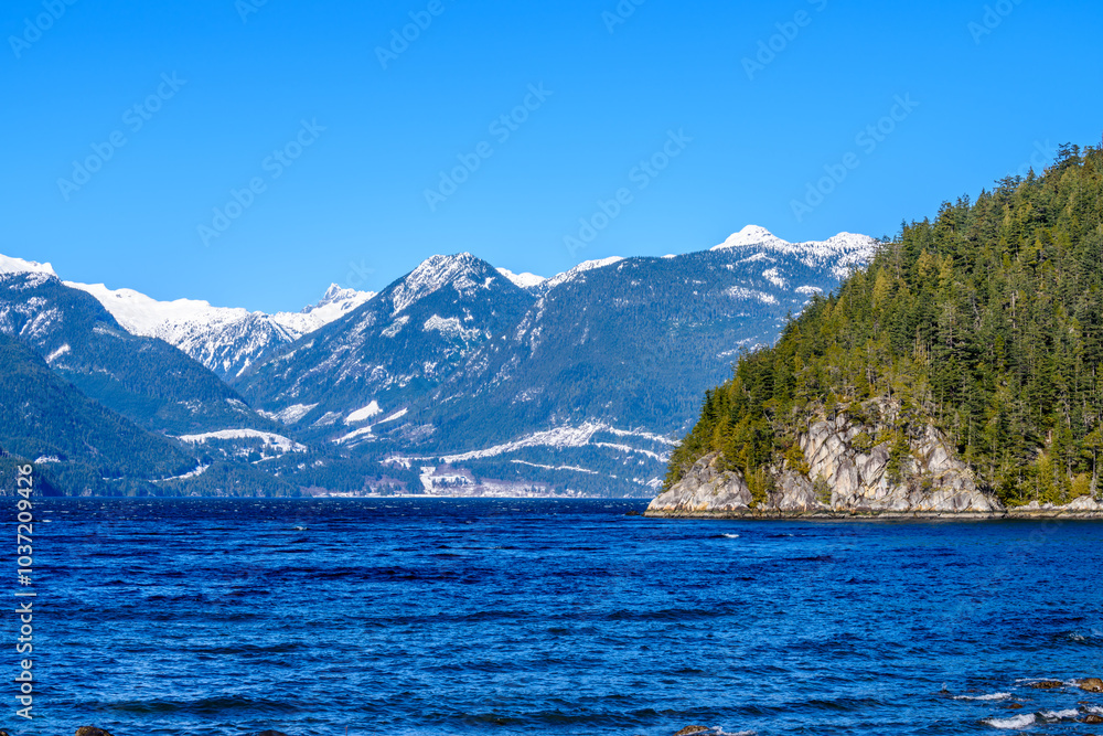 Fantastic view over ocean, snow mountain and rocks at Sechelt inlet in Vancouver, Canada. Fantastic view over ocean, snow mountain and rocks at Sechelt inlet in Vancouver, Canada.