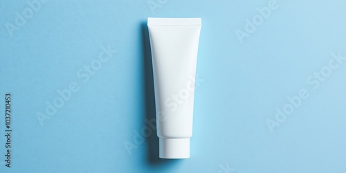 White tube of lotion on blue background