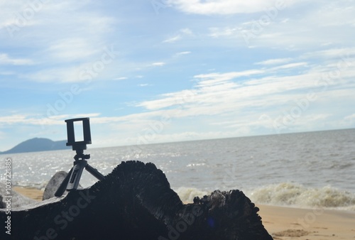 tripod on wood on the beach
