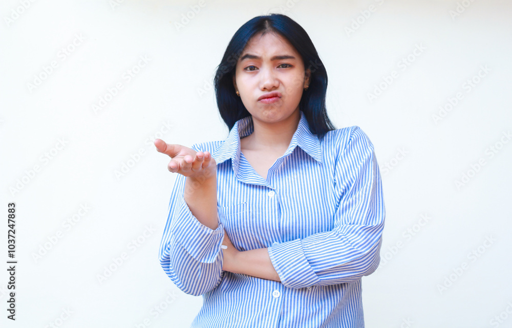 confused asian woman wearing casual stripes shirt pointing finger to empty space thinking choices standing over isolated white background confused asian woman wearing casual stripes shirt pointing finger to empty space thinking choices standing over isolated white background