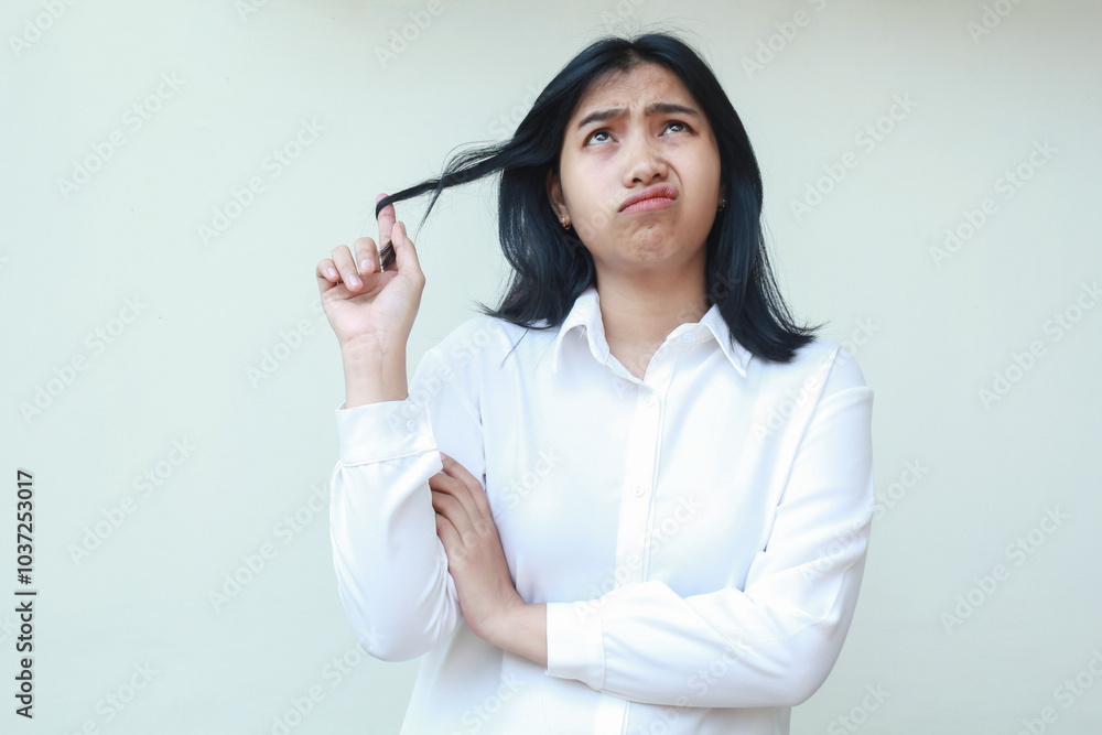 thoughtful asian young business woman manager wearing white suit shirt formal looking up confusing and grabbing her dark hair with arms folded, standing and whising, thinking of problem solution thoughtful asian young business woman manager wearing white suit shirt formal looking up confusing and grabbing her dark hair with arms folded, standing and whising, thinking of problem solution