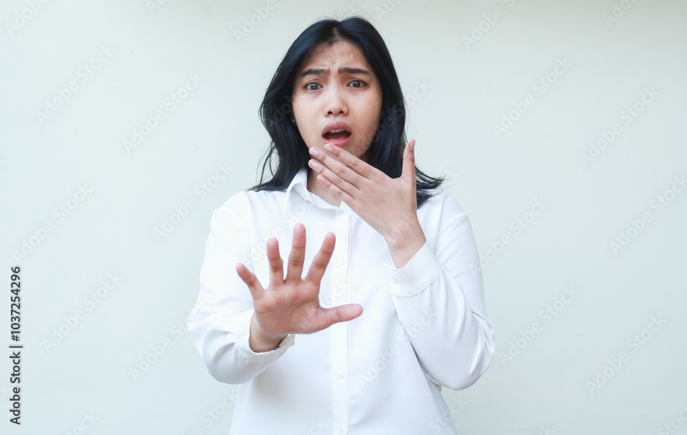 portrait of terrified shock asian business woman reaching hands towards camera and covering mouth looking at camera show frightened face expression wear white shirt formal suit standing isolated portrait of terrified shock asian business woman reaching hands towards camera and covering mouth looking at camera show frightened face expression wear white shirt formal suit standing isolated
