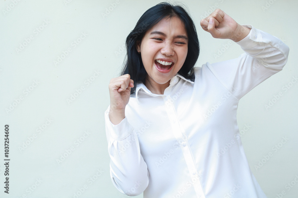 ecstatic enthusiastic asian business woman raising fist showing yes gesture celebrating her success wearing white formal shirt isolated on white background, champion dance ecstatic enthusiastic asian business woman raising fist showing yes gesture celebrating her success wearing white formal shirt isolated on white background, champion dance