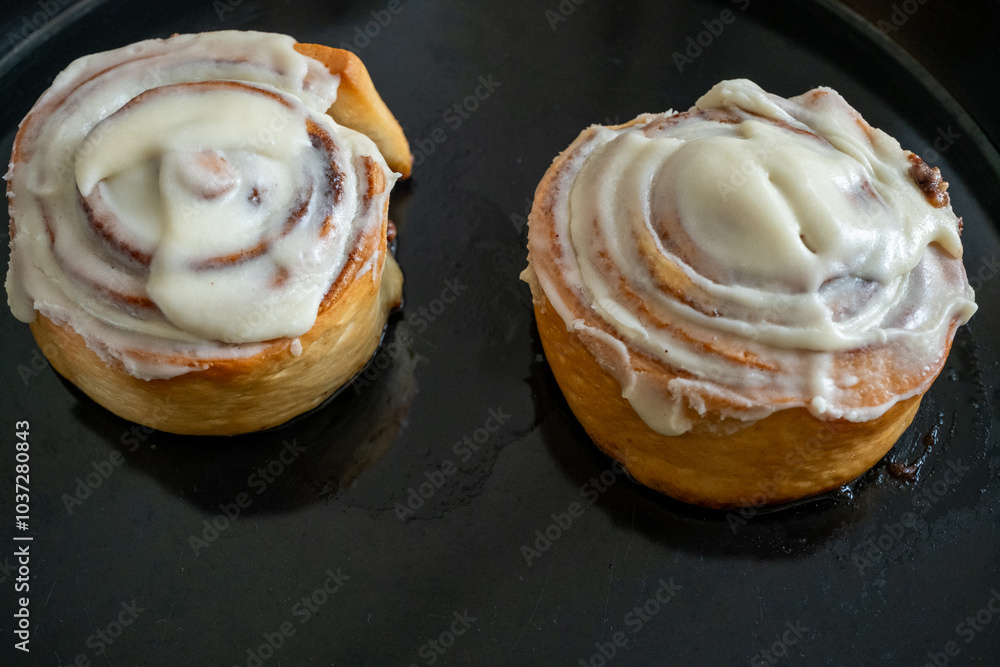 Traditional northern European dessert Cinnamon roll on plate on wooden background Traditional northern European dessert Cinnamon roll on plate on wooden background