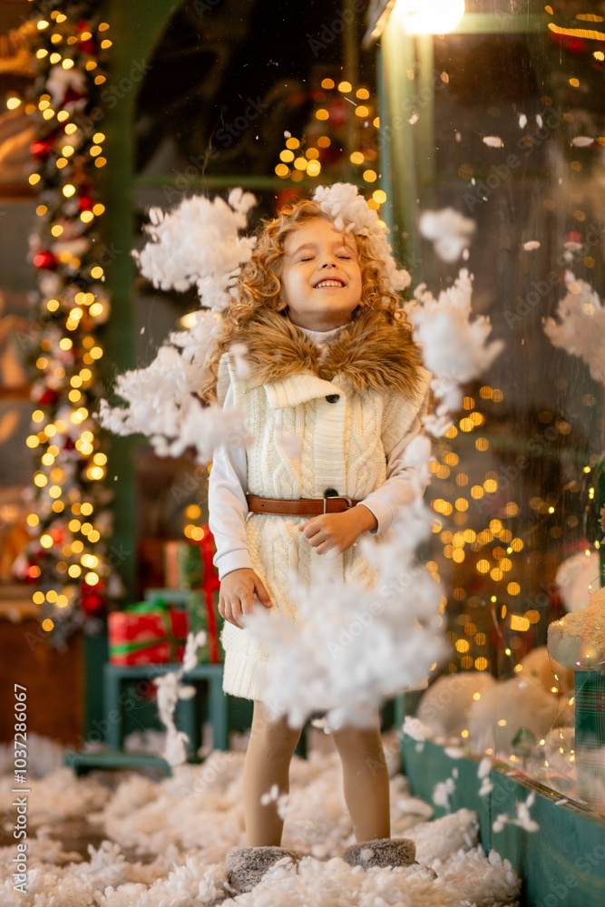 A little curly girl throws artificial snow in the interior of the Christmas studio. dreams and joys Christmas Eve. Christmas. The holiday is coming A little curly girl throws artificial snow in the interior of the Christmas studio. dreams and joys Christmas Eve. Christmas. The holiday is coming