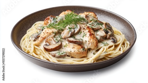 A plate of spaghetti with chicken, mushrooms, and a creamy sauce.