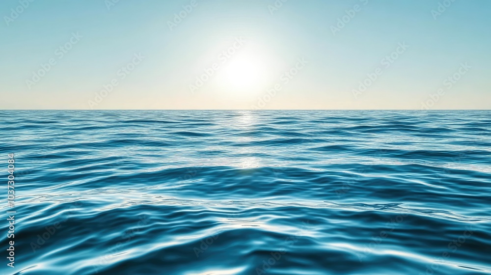 Naklejka premium A reflective ocean surface with calm waves gently moving across a sunlit horizon, under a clear sky.