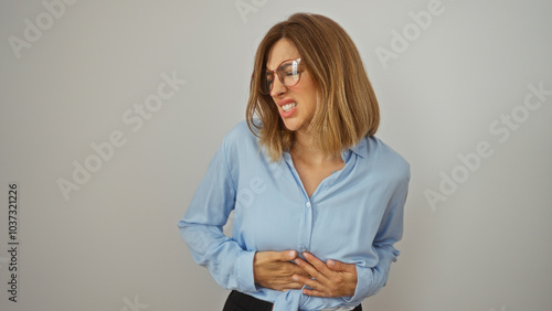 Tableau sur toile Woman holding stomach in pain over white background
