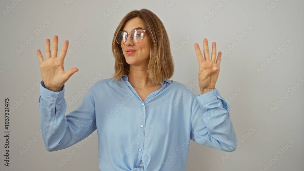 Attractive blonde woman in blue shirt showing the number nine with fingers over isolated white background Attractive blonde woman in blue shirt showing the number nine with fingers over isolated white background