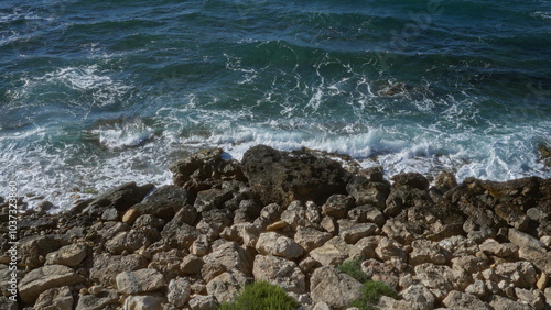 A stunning seaside view in gallipoli, puglia, italy, featuring the rocky coastline blended with the vibrant blue waves of the mediterranean sea.