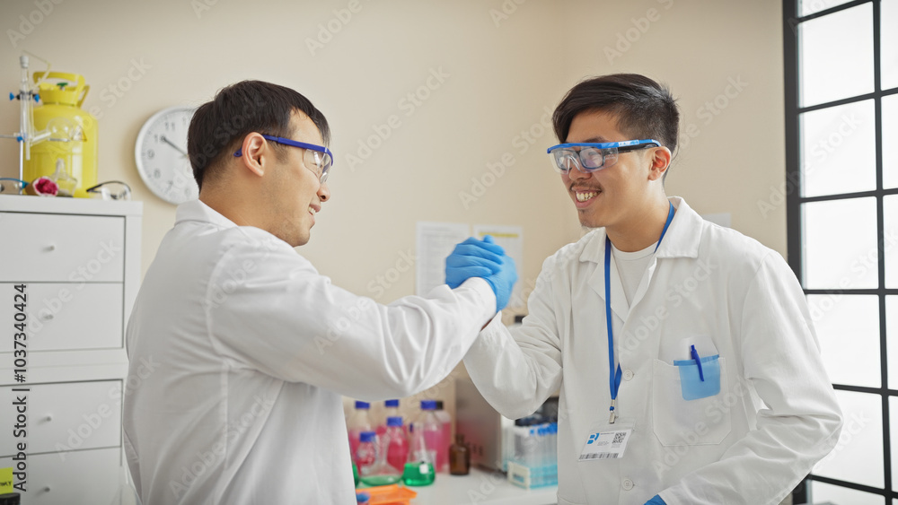 Two men in lab coats shaking hands in a chemistry laboratory, conveying teamwork and scientific collaboration. Two men in lab coats shaking hands in a chemistry laboratory, conveying teamwork and scientific collaboration.