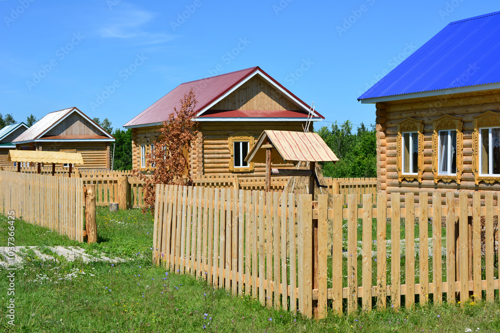 a wooden fence with some houses with a red roof and a blue roof rustic a wooden fence with some houses with a red roof and a blue roof rustic