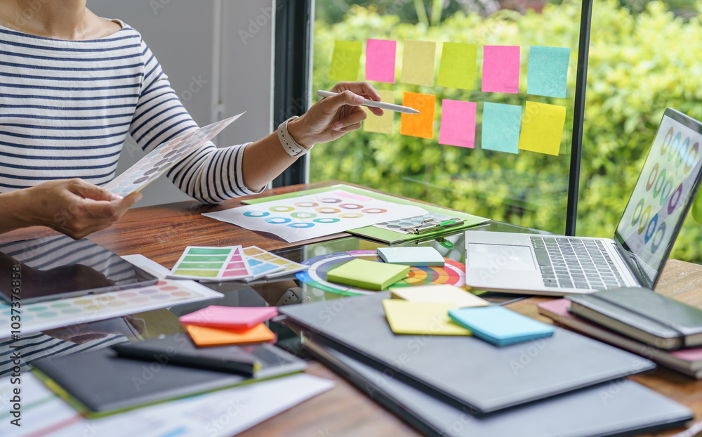 Teamwork brainstorming Creative idea Business project. Business People meeting taking notes while discussing with Color swatch samples to share idea Teamwork brainstorming Creative idea Business project. Business People meeting taking notes while discussing with Color swatch samples to share idea