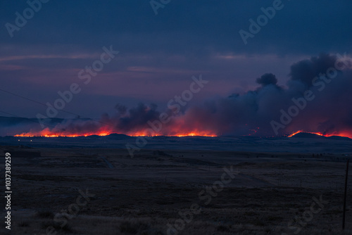 Wyoming wildfire landscape glowing fire at dusk night time guernsey forest fire