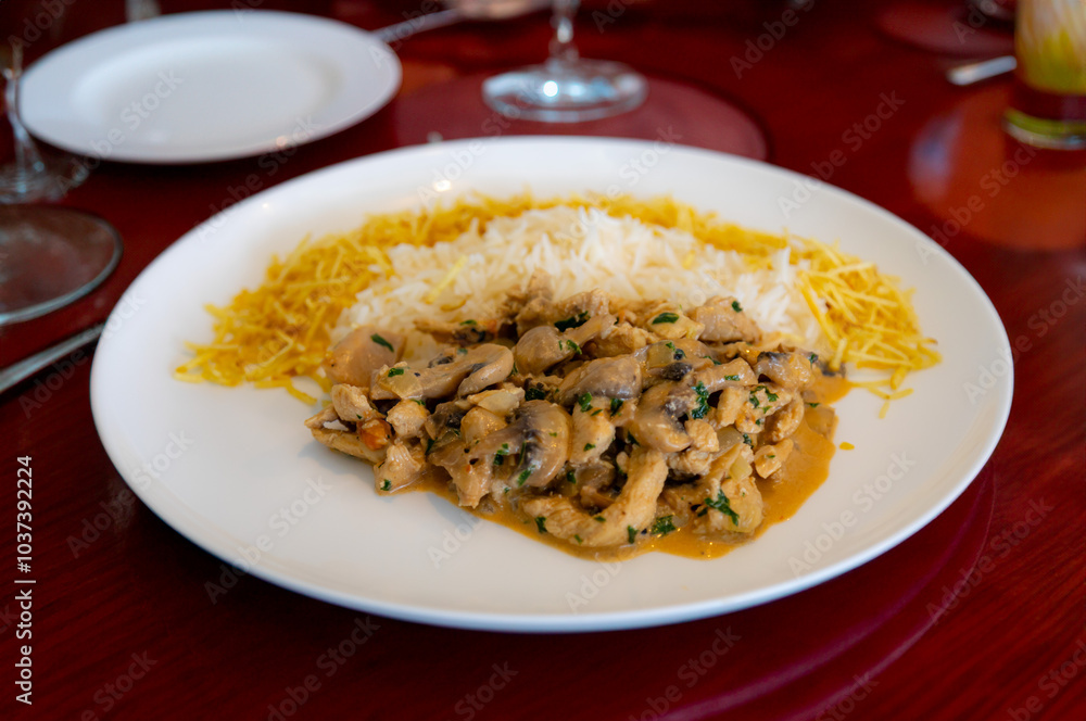 Traditional chicken stroganoff with mushrooms, straw potatoes and white rice Traditional chicken stroganoff with mushrooms, straw potatoes and white rice