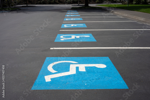 Handicapped parking signs on the ground in a parking lot.