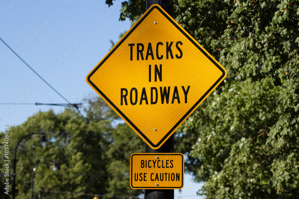 Tracks in Roadway and Bicycles Use Caution signs. Tracks in Roadway and Bicycles Use Caution signs.