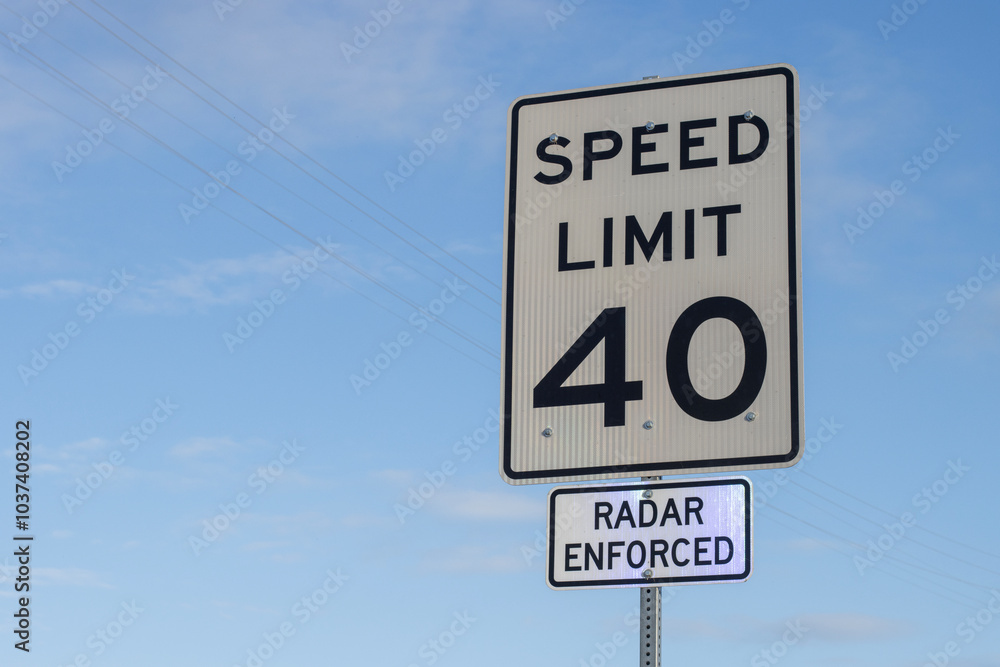 Radar enforced speed limit signage against blue sky and clouds. Radar enforced speed limit signage against blue sky and clouds.