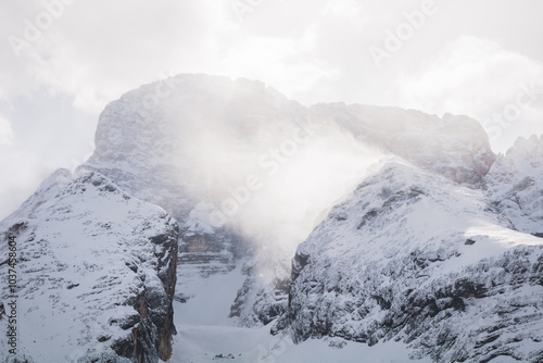 Close-up of snowdrifts on a snowy peak close to the Croda Rossa d'Ampezzo on a sunny day with a blue sky in the Dolomites. View from the Forte di Prato Piazza on Duerrenstein. photo