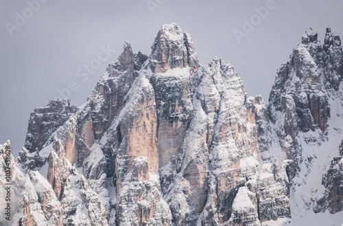 Close-up of snowdrifts on a snowy peak close to the Croda Rossa d'Ampezzo on a sunny day with a blue sky in the Dolomites. View from the Forte di Prato Piazza on Duerrenstein. photo