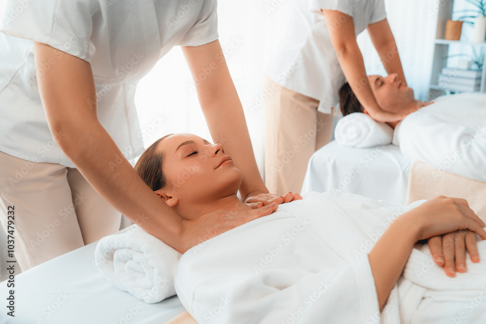 Caucasian couple customer enjoying relaxing anti-stress spa massage and pampering with beauty skin recreation leisure in day light ambient salon spa at luxury resort or hotel. Quiescent Caucasian couple customer enjoying relaxing anti-stress spa massage and pampering with beauty skin recreation leisure in day light ambient salon spa at luxury resort or hotel. Quiescent