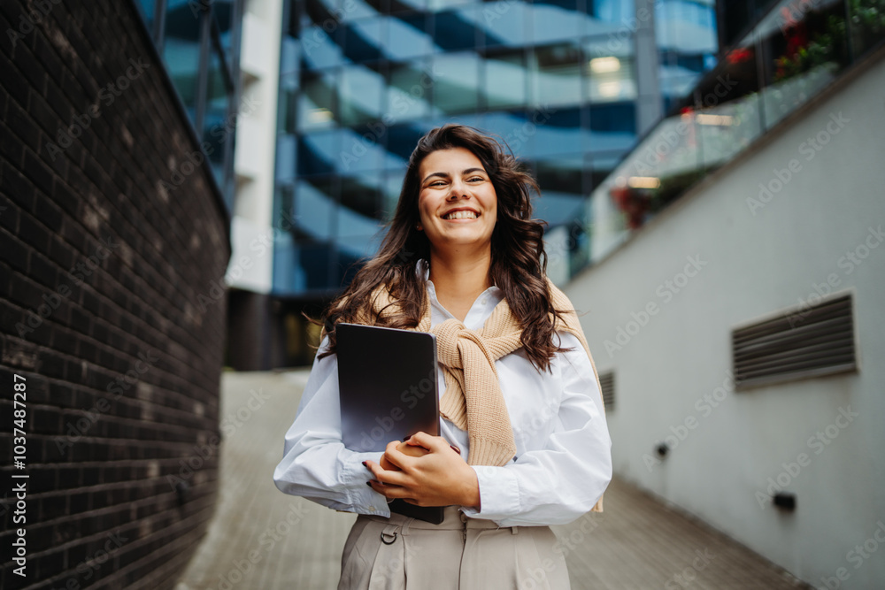 Young businesswoman going to work in front of modern business building Young businesswoman going to work in front of modern business building