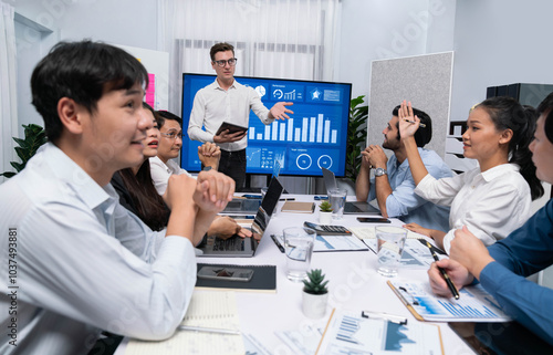 Presentation in office or meeting room with analyst team utilizing BI Fintech to analyze financial data. Businesspeople analyzing BI dashboard power display on TV screen for strategic planning.Prudent photo