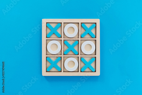 Tic tac toe game set on blue background