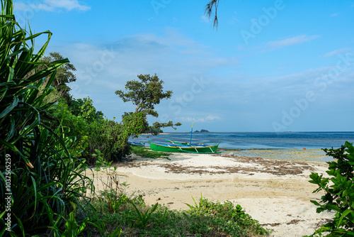 Boat by the shore of Punta Verde in Palaui Island Philippines.