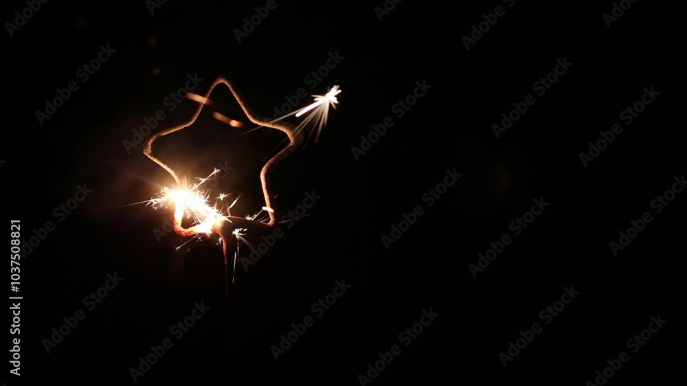 New year or Christmas party Star shape burning sparkler on black background. Bengal fire burning New year or Christmas party Star shape burning sparkler on black background. Bengal fire burning