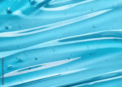Liquid gel beauty serum texture. Beauty skincare liquid blue gel background with bubbles. Skincare hygiene product closeup.	