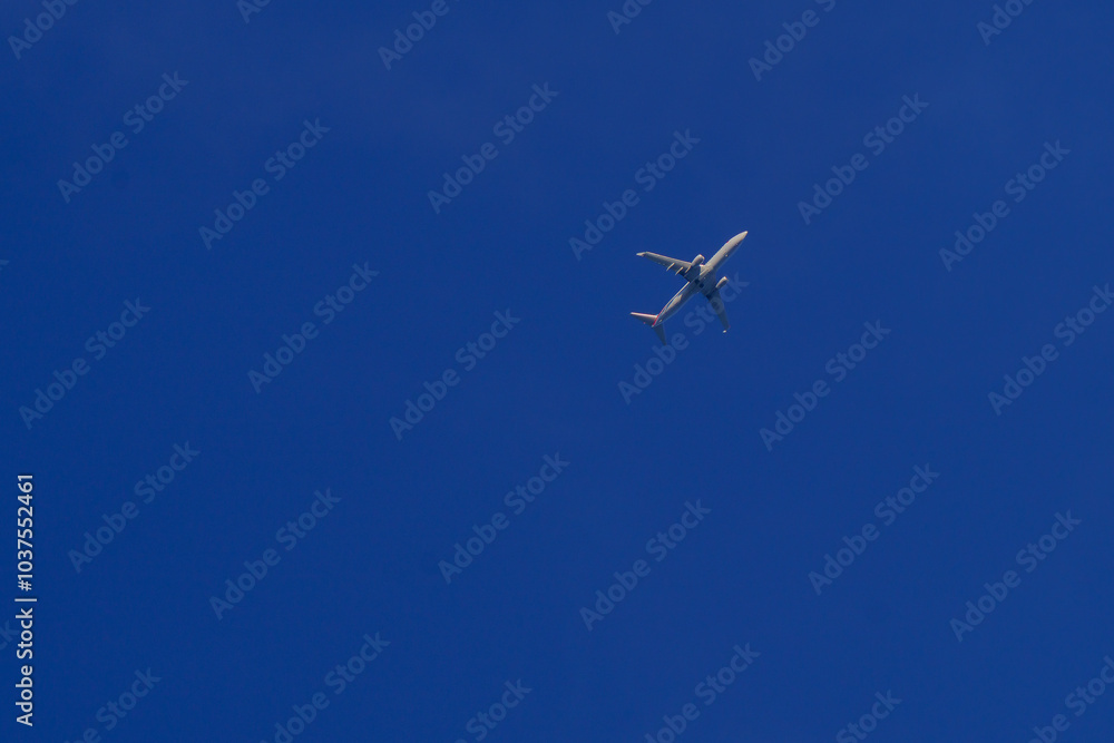 Commercial Airplane Flying in Clear Blue Sky Commercial Airplane Flying in Clear Blue Sky