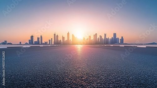 Cityscape Sunrise:Asphalt road leads to the breathtaking silhouette of a modern city skyline at sunrise. 