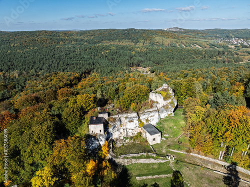 Aerial drone view of Bakowiec Knights' Castle. Eagles' Nests Trail. Autumn panorama of Ruins of Bakowiec Castle in Morsko, Poland. Castle ruins in the background autumn forest. Ruins of castle Morsko. photo