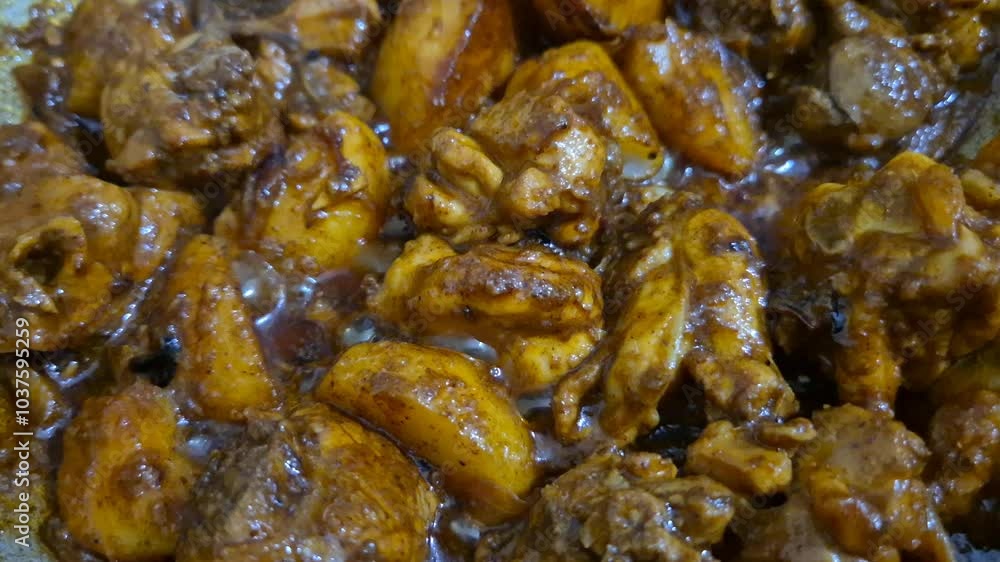 Sizzling chicken curry frying in a pan, with aromatic spices and vibrant colors, perfect for food ads, cooking shows, vlogs etc. Sizzling chicken curry frying in a pan, with aromatic spices and vibrant colors, perfect for food ads, cooking shows, vlogs etc.