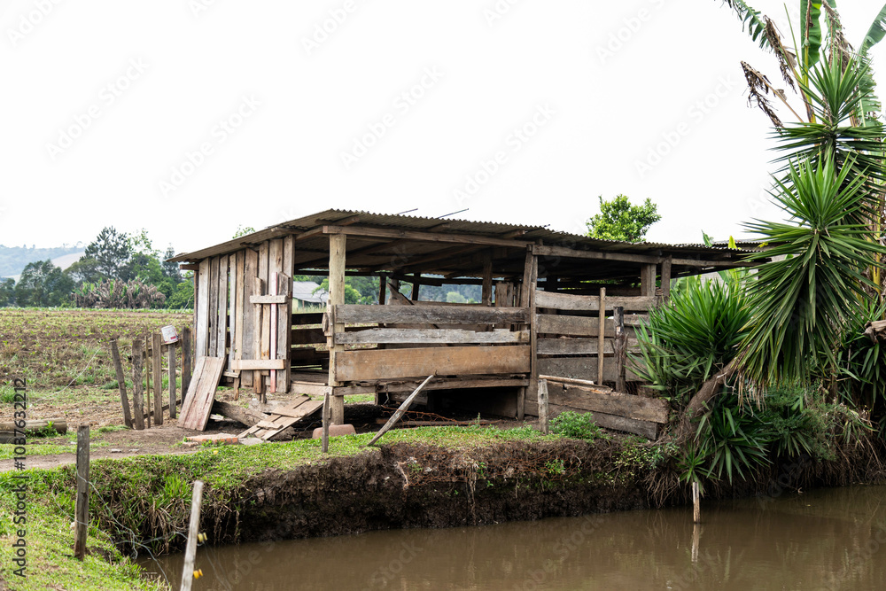 Rustic rural building in old wood for raising pigs and chickens Rustic rural building in old wood for raising pigs and chickens