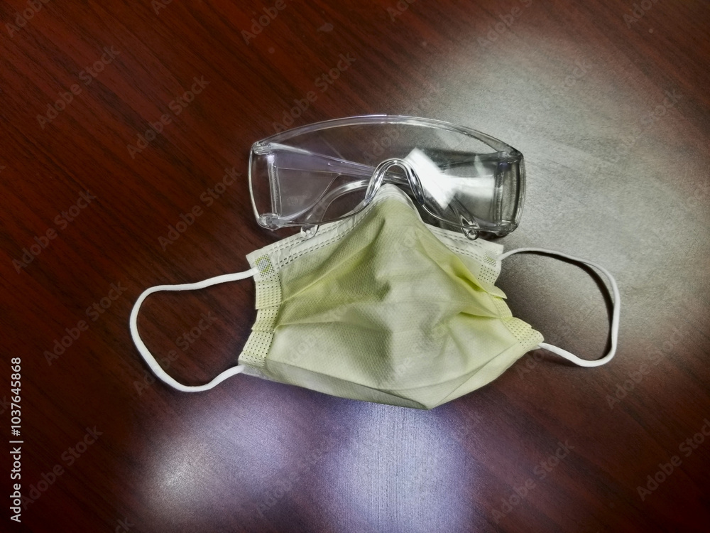 Yellow surgical mask, goggles.. Personal Protective Items Yellow surgical mask, goggles.. Personal Protective Items