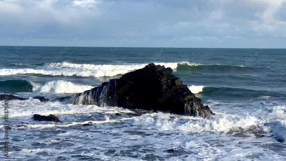 Powerful ocean waves crashing against a rugged rocky coastline in Djupivogur, Iceland, reveal nature's intense energy and dramatic beauty Powerful ocean waves crashing against a rugged rocky coastline in Djupivogur, Iceland, reveal nature's intense energy and dramatic beauty