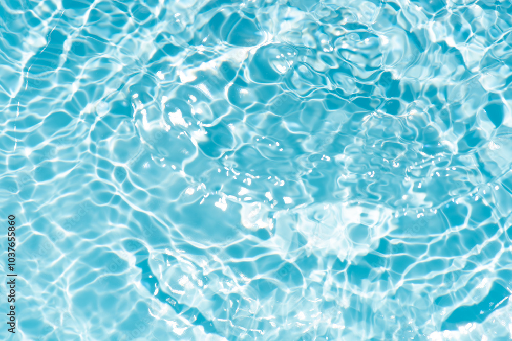 Obraz premium Blue water with ripples on the surface. Defocus blurred transparent blue colored clear calm water surface texture with splashes and bubbles. Water waves with shining pattern texture background.