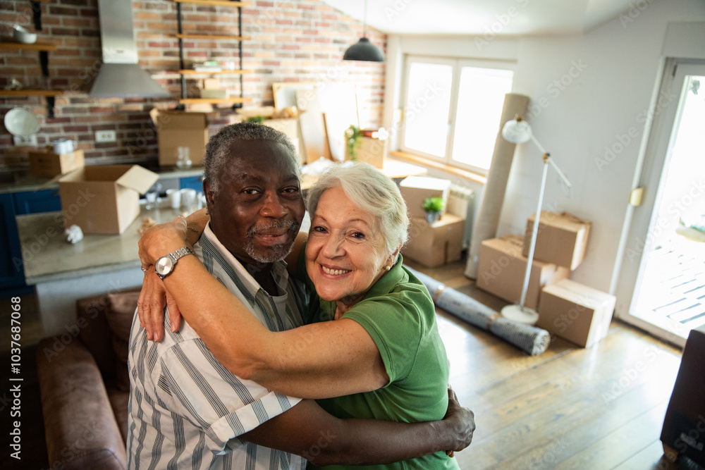 Portrait of a happy senior couple in apartment filled with moving boxes Portrait of a happy senior couple in apartment filled with moving boxes
