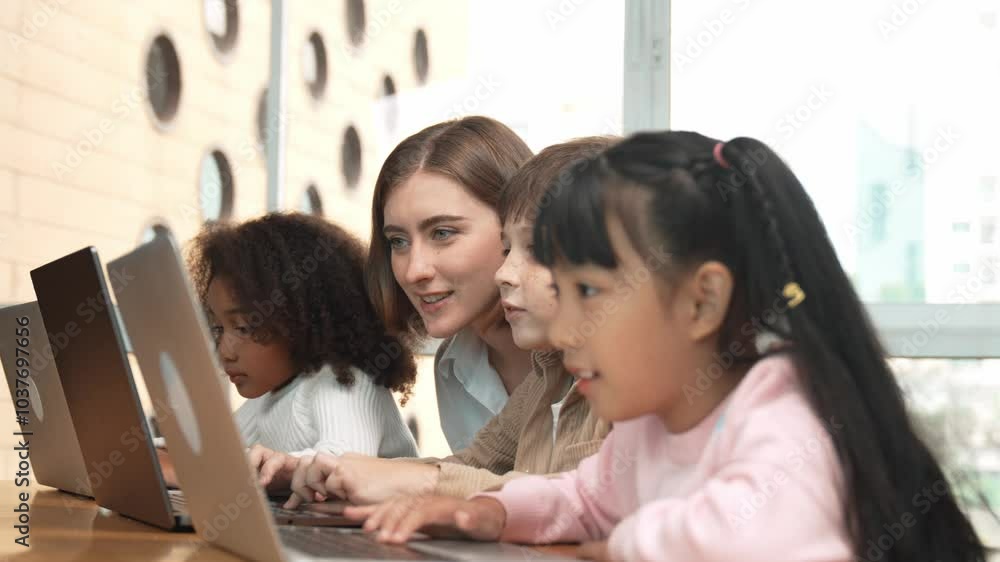 Smart teacher teaching and looking student using laptop at classroom. Professional instructor explained about programing engineering code or prompt while studying and learning program. Erudition. Smart teacher teaching and looking student using laptop at classroom. Professional instructor explained about programing engineering code or prompt while studying and learning program. Erudition.